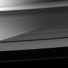 Immense Saturn is visible through the A ring as Pan coasts along its private corridor