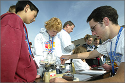 Photo of students working on their solar cars at the U.S. Department of Energy's Junior Solar Sprint/Hydrogen Fuel Cell (JSS/HFC) Car Competitions.