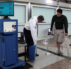 Photo of TSO screening a passenger using a CastScope