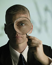 man holding magnifying glass