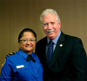 Photo of Corinne Gamino, lead TSO, Fresno (Calif.) Yosemite International Airport, taking time during her headquarters visit to pose with Mo McGowan, former assistant administrator for Security Operations.
