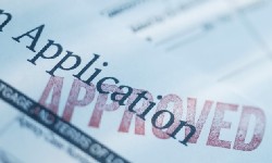 Application form stamped with APPROVED