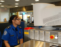 Photo of a TSO looking at an x-ray monitor