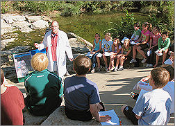 The Stream Doctor, alias EPA Scientist Gary Welker (in lab coat), teaches students from Corinth Elementary School in Prairie Village, Kan