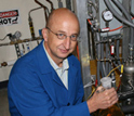 Photo of Randy Cortright holding a flask filled with Virent's biogasoline product.