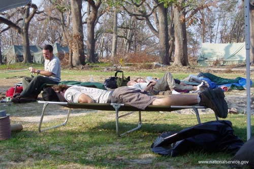 AmeriCorps members take a much-deserved break at their home base in a former city park after working all day to assist the residents of Pass Christian, Miss.