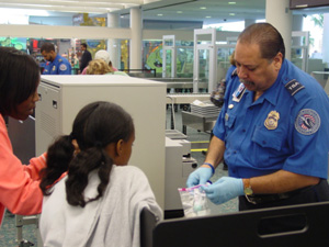 TSO Eladio Bezares assists passengers at the checkpoint. Photo by Paul Rivosecchi