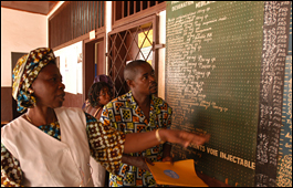 Health workers looking at the price list at a health care clinic in Central African Republic.
