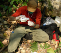 Photo of graduate student Brian Szekely conducting a fecal analysis on chimpanzee stool samples.