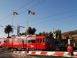 Photo of San Diego Metropolitan trolley traveling along the U.S.-Mexico border near the San Ysidro station.