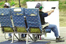 Photo of Federal Air Marshals sitting in plane seats at a firing range