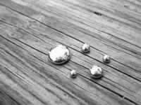 photo of mercury beads on a wooden floor