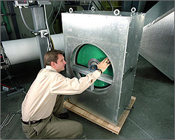 Photo of researcher inspecting a desiccant wheel prototype