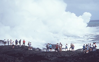 People watching lava enter the sea on the south coast of Kilauea Volcano