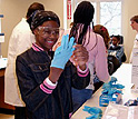 Photo of girl putting on gloves in the lab.