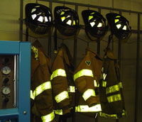 Photo of firemen's jackets and hats hanging on wall