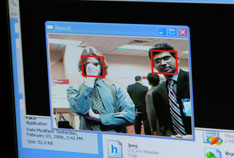 Photo of WVU's Arun Ross (left) demonstrating face recognition to NSF's Josh Chamot