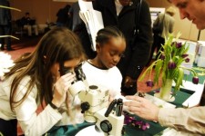 students looking through the microscope at the plant modeling exhibit