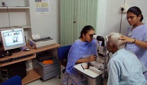 photo of a nurse and doctor conducting an eye exam for a patient