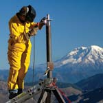 EarthScope worker wedling GPS station on the flanks of Mt. St. Helens
