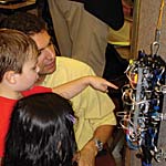 children looking at a robot that is climbing a wall