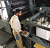 Man monitoring print job.