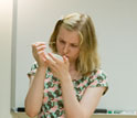 Photo of student scraping colonies off an agar media plate