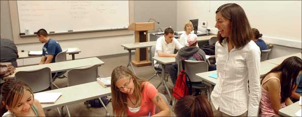 students and professor share a laugh during class discussion