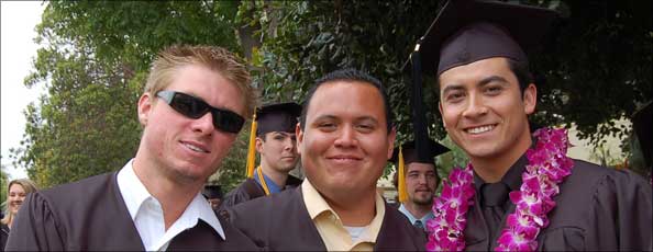 three male graduates happily post for the camera