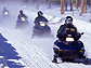 Several people on their snowmobiles.