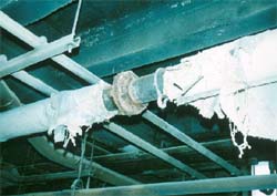 Damaged asbestos pipe lagging in sawmill basement.