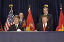 Participants sign during the US/Vietnam Signing Ceremony