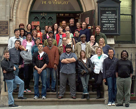     A mixed race and gender group of more than thirty people pose for a picture on the front steps of a former church building, now the headquarters of New Dramatists.								