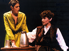 two young actors have a conversation on stage, their pointy elf ears are in evidence.