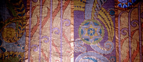 Decorative motifs with twirling shapes painted in gold, blues and violets.		
