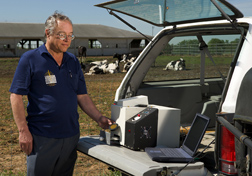 Chemist analyzes manure for nitrogen in the field using a prototype near-infrared filter spectrometer: Click here for full photo caption.