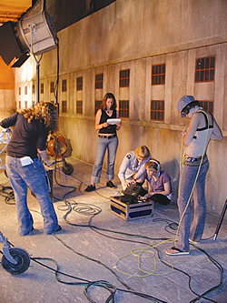         Young women in a movie set occupied in different tasks										