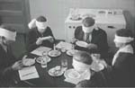 Photo: Blindfolded subjects participating a taste panel, 1930s
