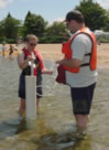 USGS scientists sampling ground water from a well installed at a beach as part of a study of bacterial contamination at beaches