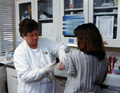 A nurse gives a patient an injection.
