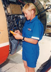 A female mechanic inspects a jet engine.