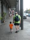 A father walks with his young son.