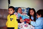 A grandmother reads to her grandchildren.