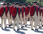 People dressed in colonial soldier costumes.