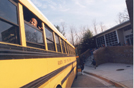 A school bus in front of a school.