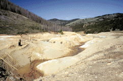 Tailings filling the High Ore Creek valley, Boulder River watershed southwestern Montana in 1997. The creek eroded a channel through the tailings, washing them down to the Boulder River and enriching the water with metals.