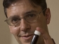 George Huber poses with a vial of green gasoline compounds.