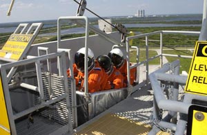The Expedition 6 crew practice emergency egress from the 195-foot level of the Fixed Service Structure on Launch Pad 39A.