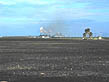 photo of harvested sugarcane field and sugarcane processing plant