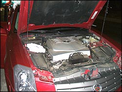 Cocaine hidden under hood of Cadillac.